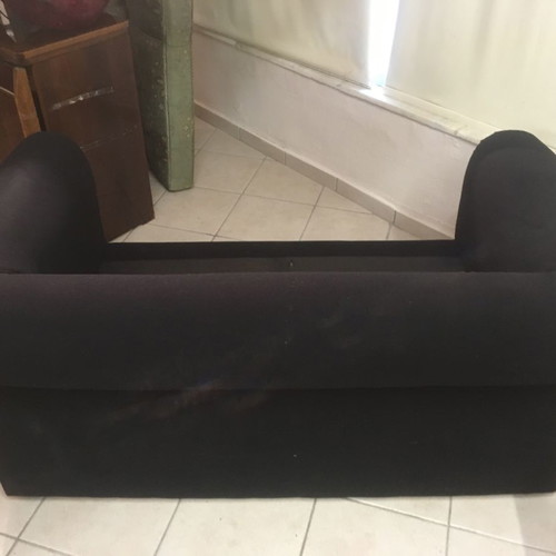 Two-seater black sofa used with wooden legs and washable fabric