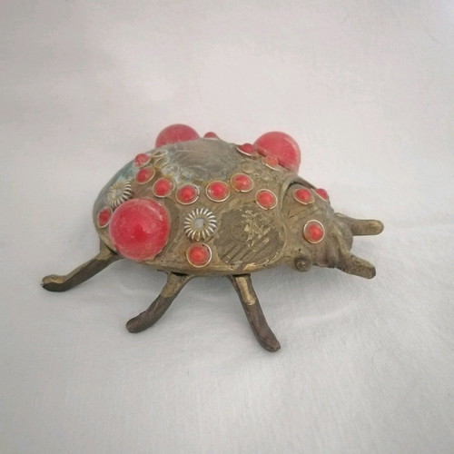 Bronze ashtray used with red scarab-shaped stones