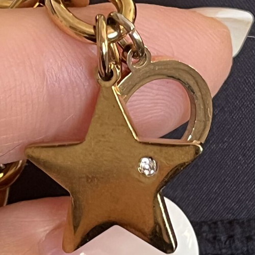 Steel bracelet used with gold tone and star charm with zircon