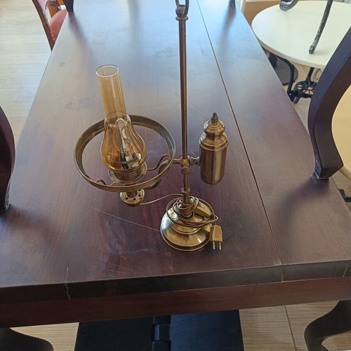 Retro table lamp made of brass used, oil lamp style with amber glass chimney