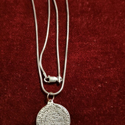Necklace with 9.25 silver chain and Phaistos disc like new
