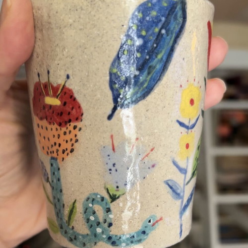 Illustrative ceramic mug handmade with floral design