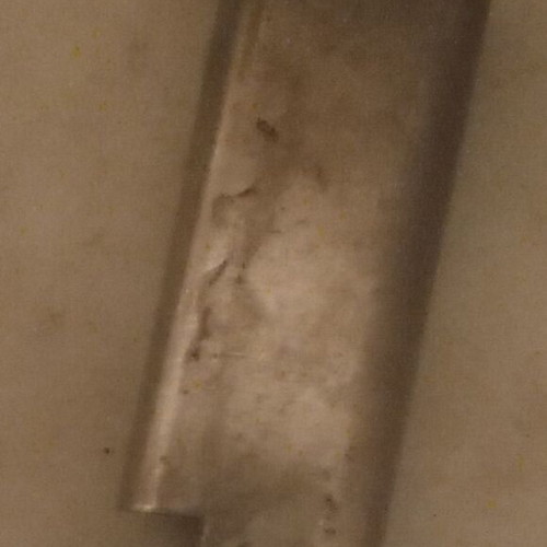 Metal case for flat lighter used with visible signs of wear