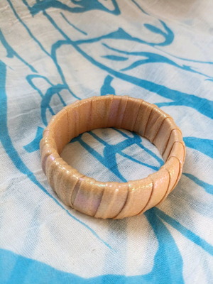 Handmade bracelet from shiny fabric in beige and pink shades