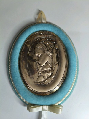 Decorative icon of Virgin Mary with divine infant used, oval metal