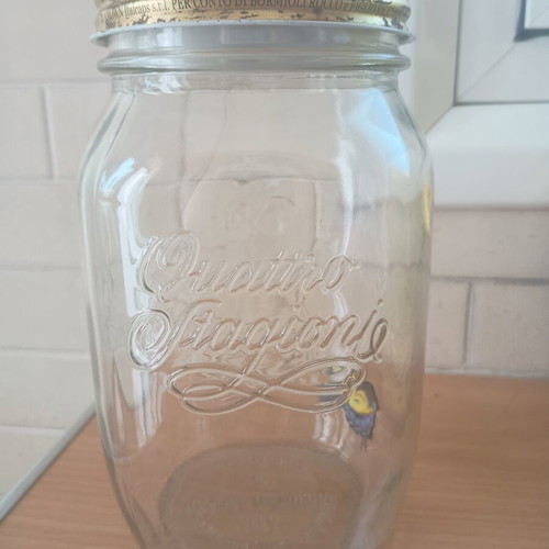Decorative jar with moving butterfly mechanism