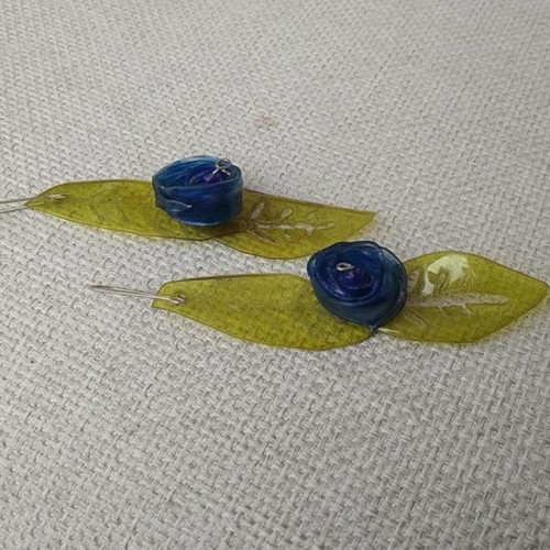 Earrings handmade from scratch with blue and green recycled plastic flowers and leaves