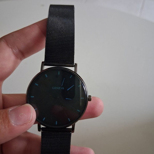 Geneva wristwatch used with black mesh metal strap