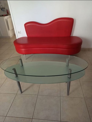 Red sofa and glass coffee table