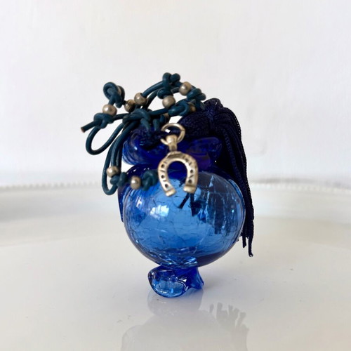 Handmade glass lucky charm in blue shades with horseshoe and silk tassel