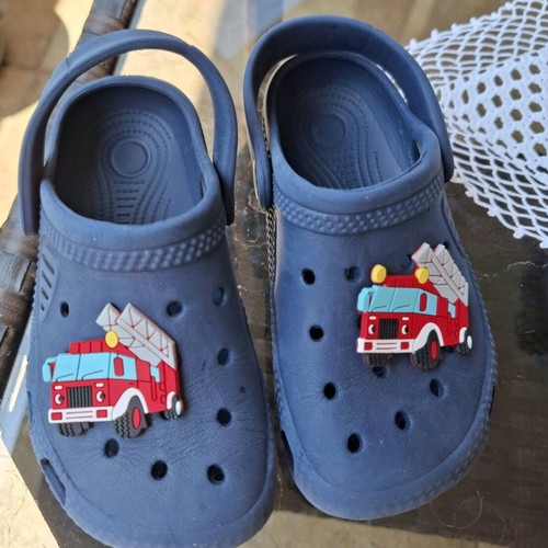 Kids Cros slippers size 25 like new, blue with fire truck figure