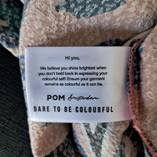 Pom dress used with geometric pattern in pink, blue and green