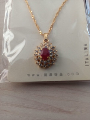 Necklace new with zircon and ruby stone in center