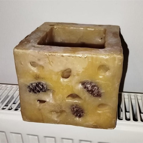 Decorative candle like new with pine cones and dried fruits