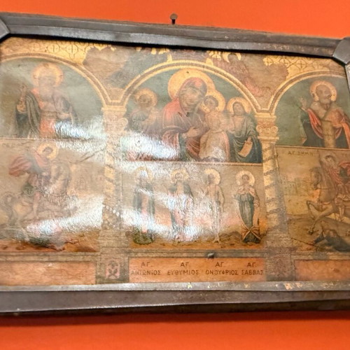 Old multi-themed religious icon on wood with glass used