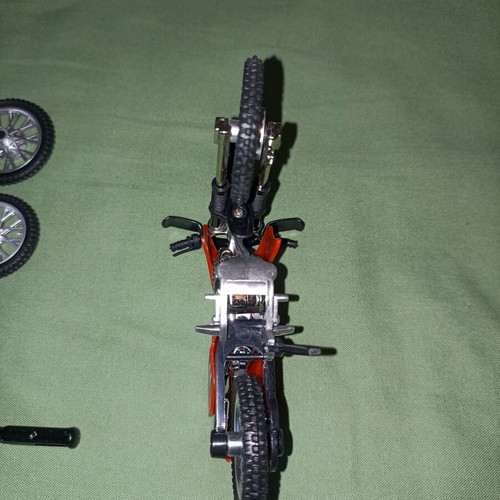 Motocross toy miniature new with extra wheels and nuts