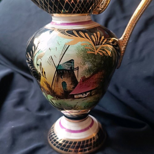 Antique porcelain jug used with hand-painted windmill scene