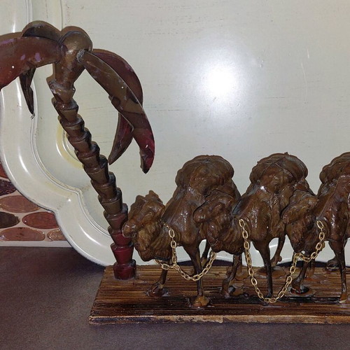 Decorative item used with camels and palm tree made of wood and plastic