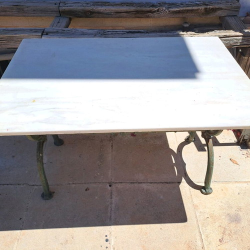 Table with cast iron base and marble used