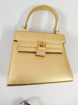 Gold Handbag like new with rhinestone clasp