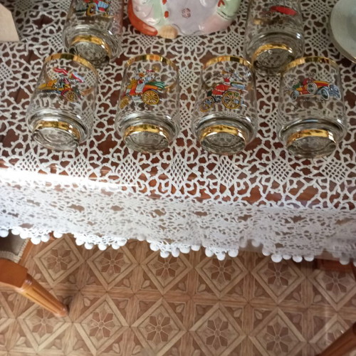 Crystal glasses with gold trim and vintage car designs like new