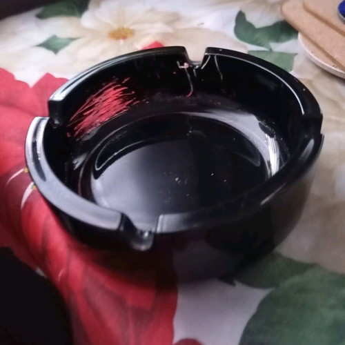 Glass ashtray vintage black classic with four cigarette slots used