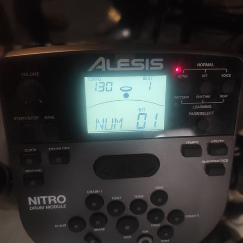 Alesis Nitro Mesh Kit electronic drums with Sony headphones and drumsticks holder