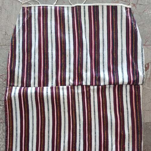 Traditional apron with vertical stripes used