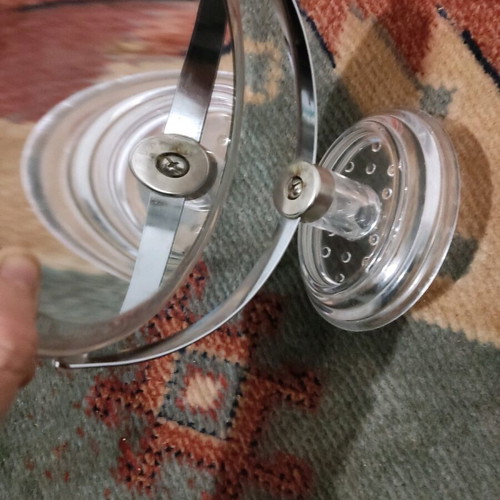 Small mirror used with magnifying side