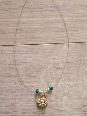 Necklace used with green and transparent beads and crown charm
