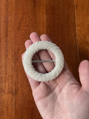 Belt buckle with small white beads
