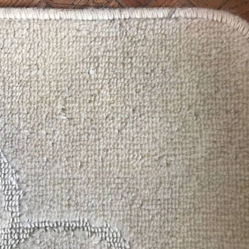 Beige rug with pattern and non-slip backing, new