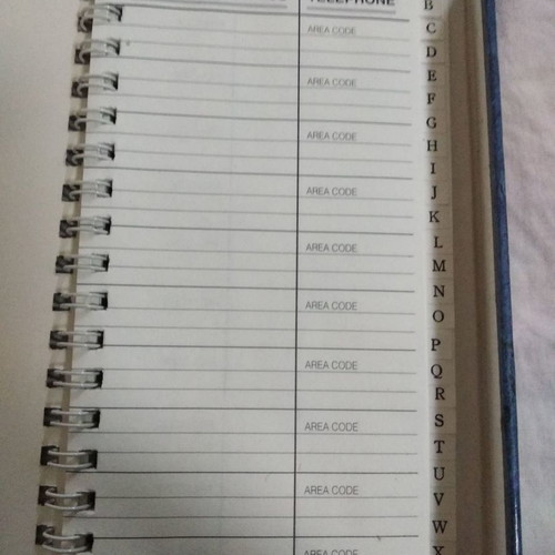 Phone book with magnetic closure and pen holder