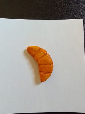 Handmade croissant magnet from clay