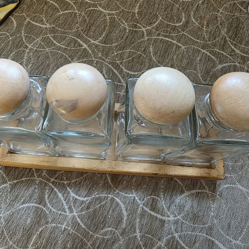 Set of 4 glass jars with wooden lids and wooden base like new