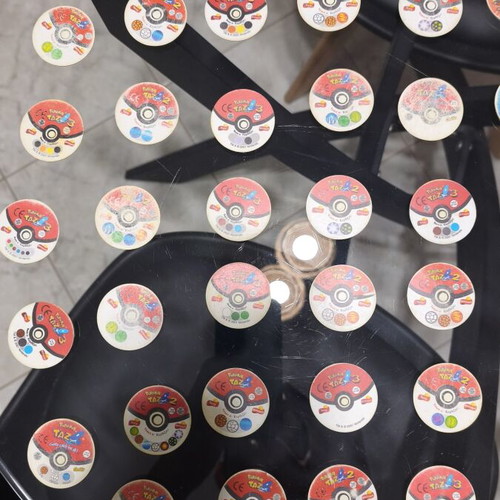 Pokemon Tazos used with visible wear