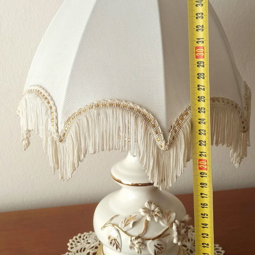 Vintage porcelain table lamp with fabric white shade and fringes used