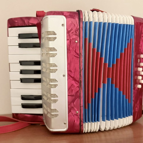 Children's accordion used, red with blue and red bellows