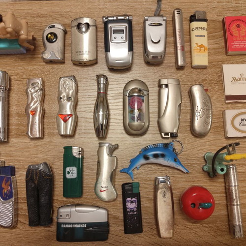Collection of 25 used vintage lighters and 3 matchboxes from hotels and restaurants