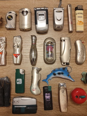 Collection of 25 used vintage lighters and 3 matchboxes from hotels and restaurants