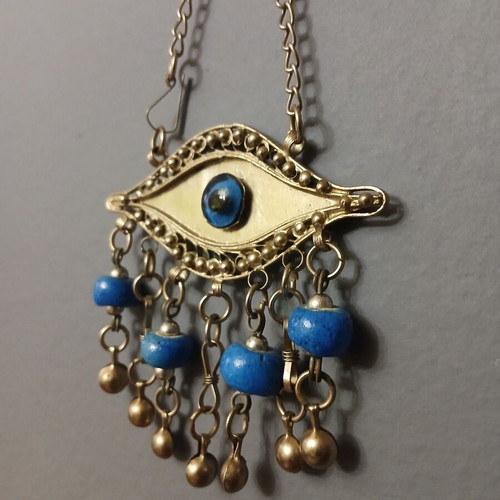 Vintage metal evil eye decoration used, silver with blue beads