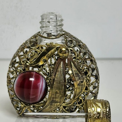 Vintage perfume flacon with filigree metalwork and red cabochon