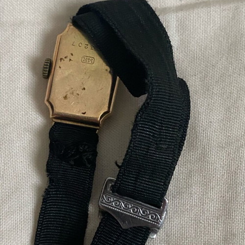 Vintage women's wristwatch used with 14K gold and black strap