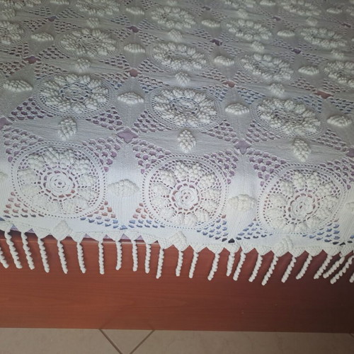 Handmade super double blanket with embossed designs and crocheted fringes