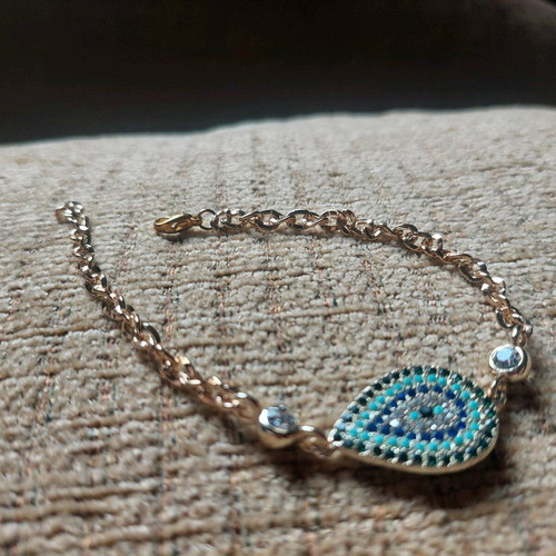 Gold bracelet new with eye and blue, turquoise, white stones