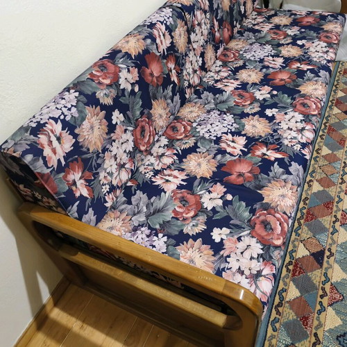 Three-seater sofa with pull-out bed and floral upholstery