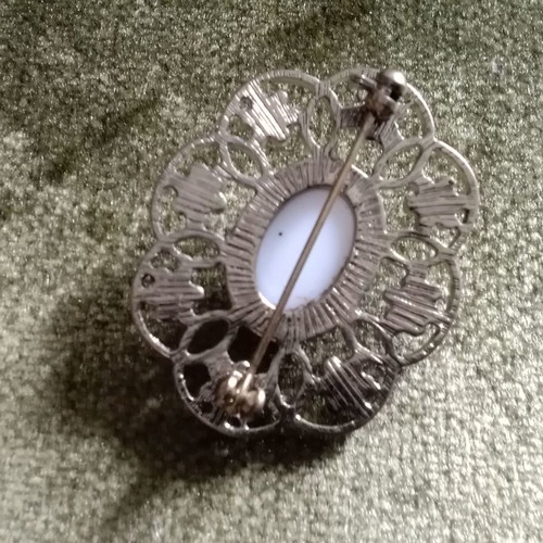 Metal brooch with porcelain detail used