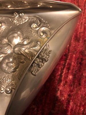 Decorative triangular vessel used with embossed flowers