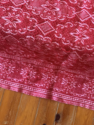Vintage red wool blanket with geometric and floral patterns
