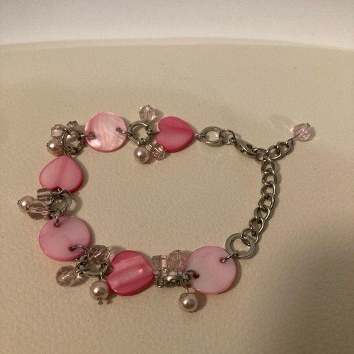 Silver bracelet with pink hearts in a box